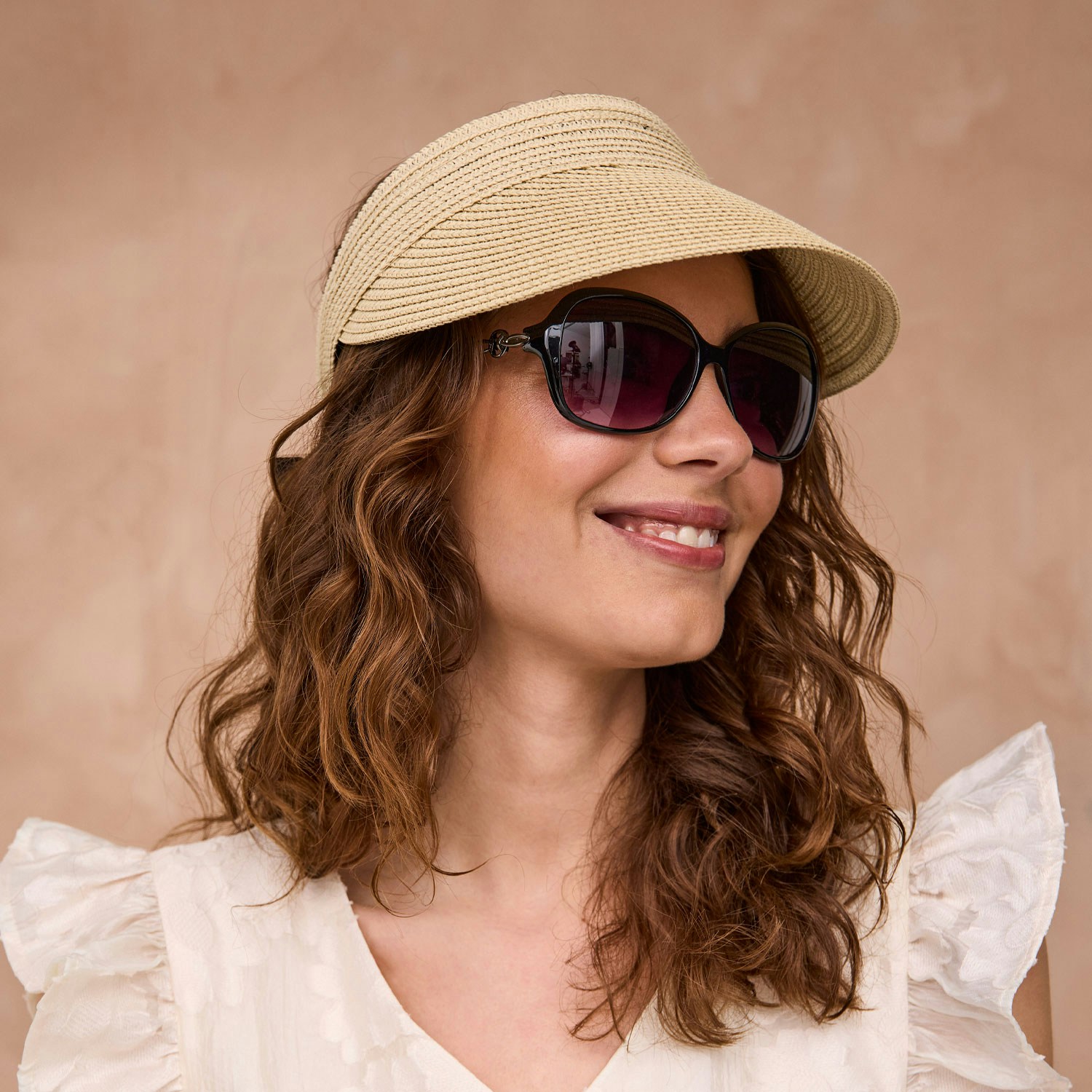 En kvinde med solbriller og solhat. Køb solbriller og solhatte hos BilkaToGo.